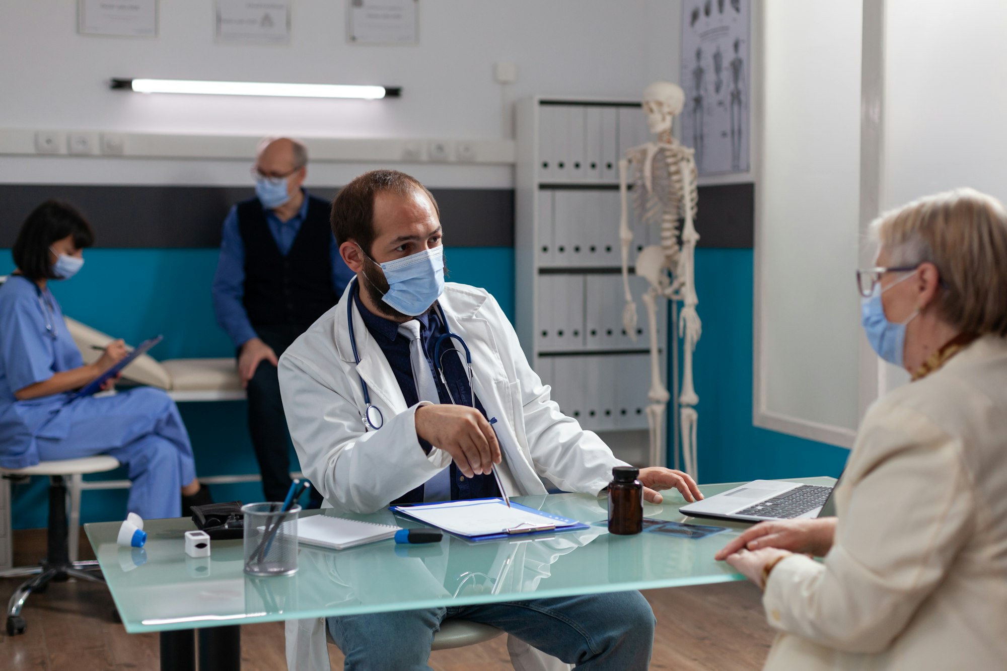 Man doctor consulting retired patient at annual checkup visit