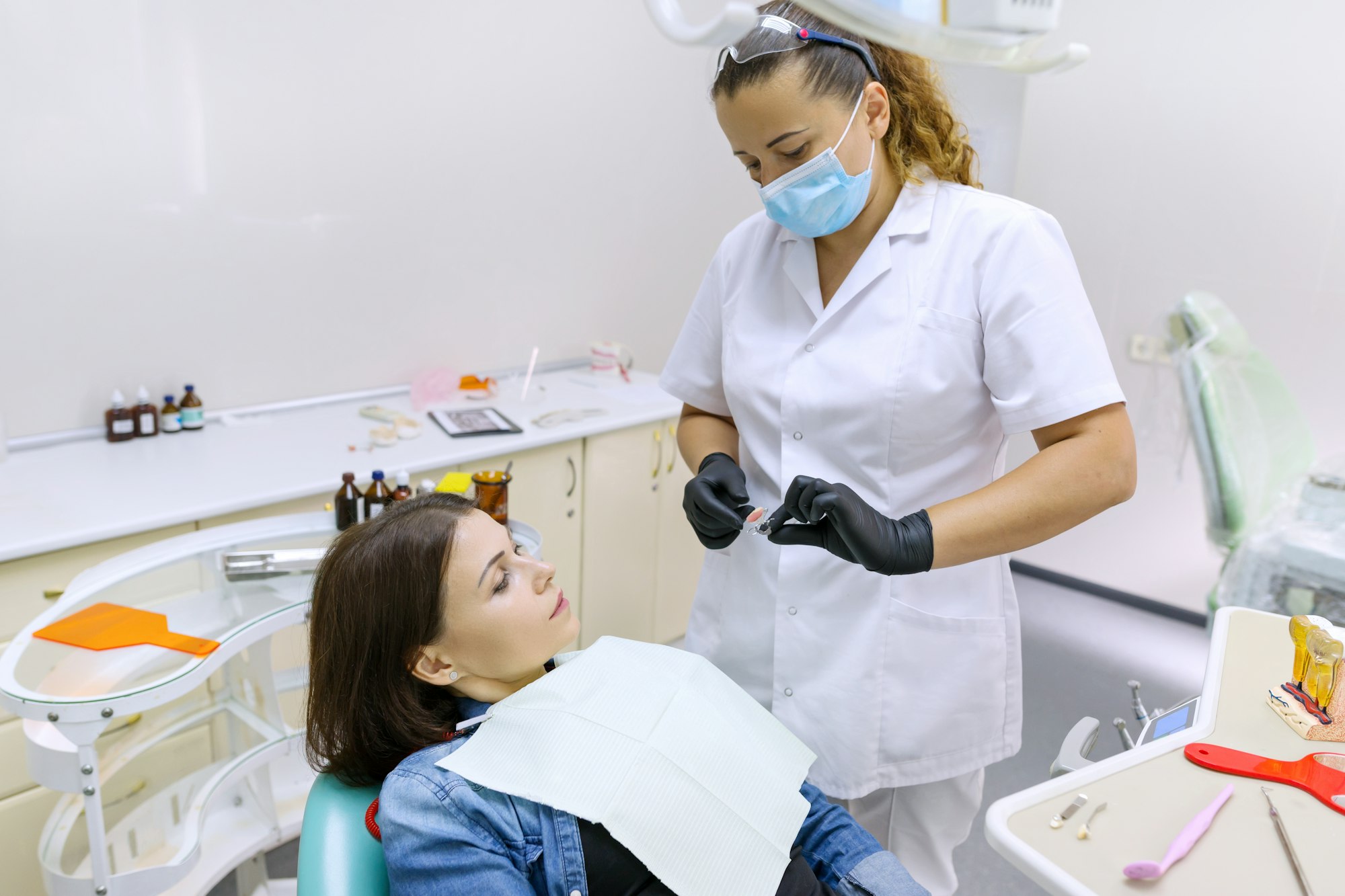 Partial denture, mature woman patient sitting in dental chair