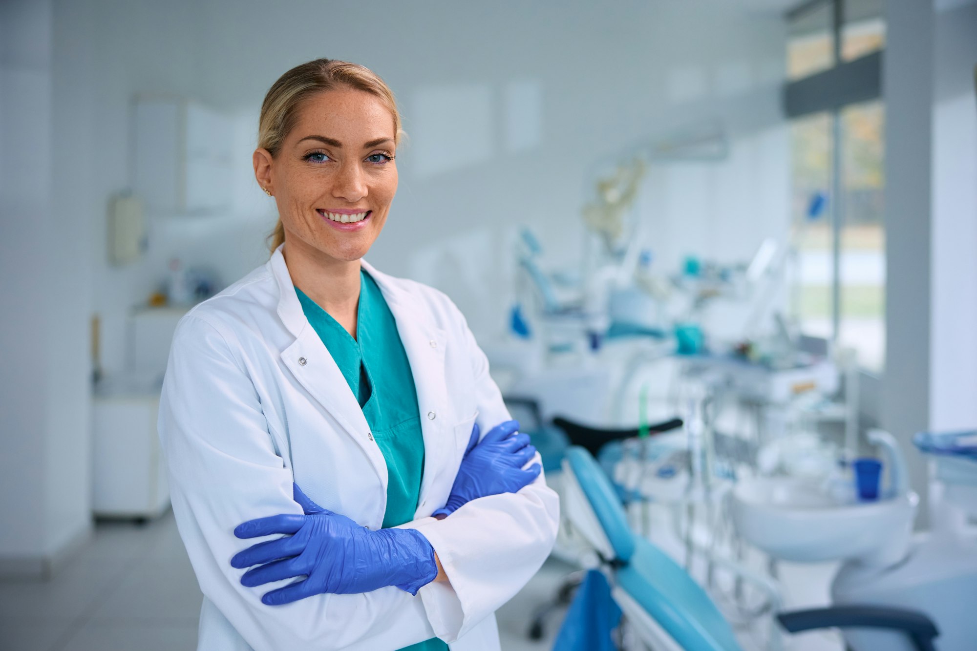 Confident female dentist at dental clinic looking at camera.