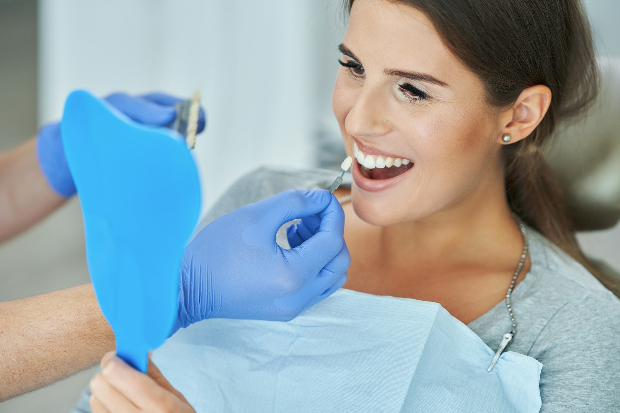 Male dentist and woman in dentist office